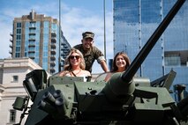 A U.S. Marine with 2d Light Armored Reconnaissance Battalion, Special Purpose Marine Air-Ground Task Force-250, poses for a photo with civilians at a static display during Marine Week Nashville, in Nashville, Tennessee, June 5, 2025. Marines set up multiple equipment displays and recruiting booths during Marine Week to engage with the community of Nashville. Throughout 2025, Marines across the globe will celebrate the 250th birthday of the Corps, commemorating, service, sacrifice, and priding themselves on living ‘Semper Fidelis’ or ‘Always Faithful’ to their nation and to each other. (U.S. Marine Corps photo by Cpl. Vincent Needham)