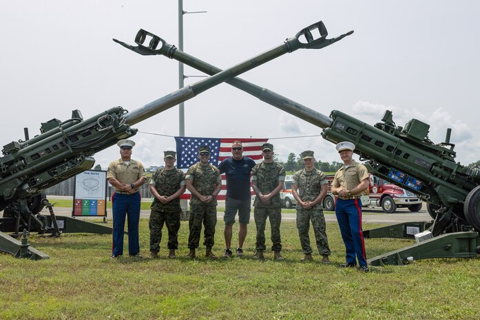 U.S. Marines from Marine Corps Installations East and an attendee from the Cracker Barrel 400 brand activation, takes a photo during Marine Week Nashville 2025 at the Nashville Superspeedway, Nashville, Tennessee, June 1, 2025. Founded on November 10, 1775, the United States Marine Corps has served our nation honorably in every clime and place for 250 years. Throughout 2025, Marines across the globe will celebrate the 250th birthday of the Corps, commemorating service, sacrifice, and priding themselves on living 'Semper Fidelis' or 'Always Faithful' to their nation and to each other. (U.S. Marine Corps photo by Lance Cpl. Judith Ann Lazaro)