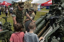 U.S. Marine Corps Cpl. Zachary Rice, a field artillery cannoneer with 1st Battalion, 10th Marine Regiment, 2d Marine Division, educates young attendees from the Cracker Barrel 400 brand activation during Marine Week Nashville 2025 at the Nashville Superspeedway, Nashville, Tennessee, June 1, 2025. Founded on November 10, 1775, the United States Marine Corps has served our nation honorably in every clime and place for 250 years. Throughout 2025, Marines across the globe will celebrate the 250th birthday of the Corps, commemorating service, sacrifice, and priding themselves on living 'Semper Fidelis' or 'Always Faithful' to their nation and to each other. (U.S. Marine Corps photo by Lance Cpl. Judith Ann Lazaro)