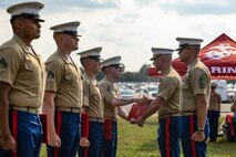 Sergeant Major of the Marine Corps Sgt. Maj. Carlos A. Ruiz and Lieutenant Colonel Dave Sierleja, the commanding officer of 2d Combat Engineer Battalion, shake hands with newly reenlisted Marines during the Cracker Barrel 400 brand activation as part of Marine Week Nashville 2025 at the Nashville Superspeedway, Nashville, Tennessee, June 1, 2025. Founded on November 10, 1775, the United States Marine Corps has served our nation honorably in every clime and place for 250 years. Throughout 2025, Marines across the globe will celebrate the 250th birthday of the Corps, commemorating service, sacrifice, and priding themselves on living 'Semper Fidelis' or 'Always Faithful' to their nation and to each other. (U.S. Marine Corps photo by Lance Cpl. Judith Ann Lazaro)