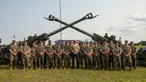 Sergeant Major of the Marine Corps Sgt. Maj. Carlos A. Ruiz, a Sonora, Mexico native, takes a group photo with Marine Corps Installations East during Cracker Barrel 400 brand activation, Marine Week Nashville 2025 at the Nashville Superspeedway, Nashville, Tennessee, June 1, 2025. Founded on November 10, 1775, the United States Marine Corps has served our nation honorably in every clime and place for 250 years. Throughout 2025, Marines across the globe will celebrate the 250th birthday of the Corps, commemorating service, sacrifice, and priding themselves on living 'Semper Fidelis' or 'Always Faithful' to their nation and to each other. (U.S. Marine Corps photo by Lance Cpl. Judith Ann Lazaro)