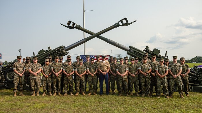 Sergeant Major of the Marine Corps Sgt. Maj. Carlos A. Ruiz, a Sonora, Mexico native, takes a group photo with Marine Corps Installations East during Cracker Barrel 400 brand activation, Marine Week Nashville 2025 at the Nashville Superspeedway, Nashville, Tennessee, June 1, 2025. Founded on November 10, 1775, the United States Marine Corps has served our nation honorably in every clime and place for 250 years. Throughout 2025, Marines across the globe will celebrate the 250th birthday of the Corps, commemorating service, sacrifice, and priding themselves on living 'Semper Fidelis' or 'Always Faithful' to their nation and to each other. (U.S. Marine Corps photo by Lance Cpl. Judith Ann Lazaro)