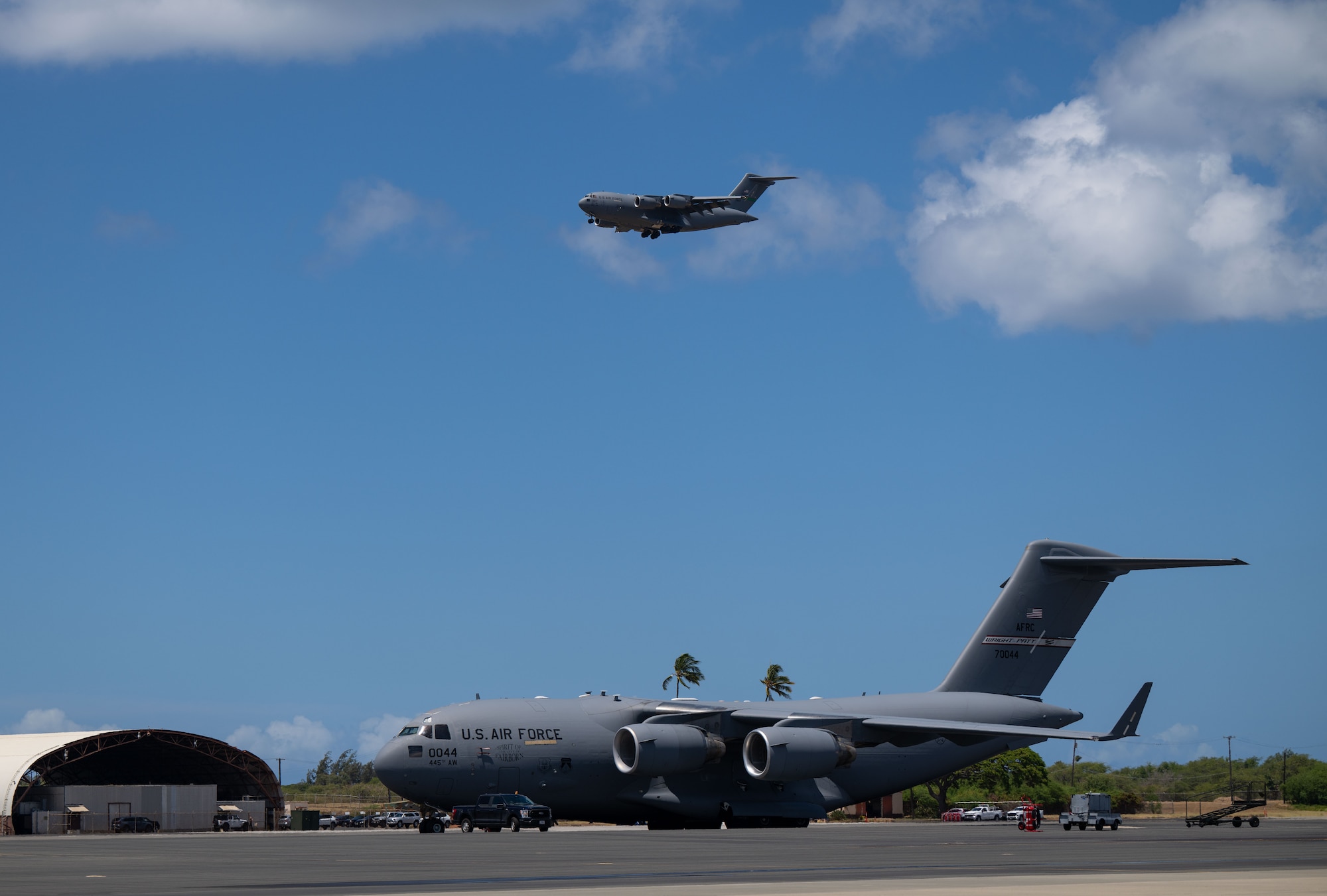 A C-5M Super Galaxy aircraft flies above the flight line in support of the Air Force’s 2025 Department-Level Exercise series at Joint Base Pearl Harbor-Hickam, Hawai’i, July 10, 2025. This exercise is part of the first-in-a-generation DLE series, a new way of conducting operations in a contested, dynamic environment to build capabilities making a stronger, more lethal deterrent force. The DLE series encompasses all branches of the Department of Defense, along with Allies and partners, employing more than 400 Joint and coalition aircraft and more than 12,000 members at more than 50 locations across 3,000 miles. (U.S. Air Force photo by Tech. Sgt. Monica Roybal)