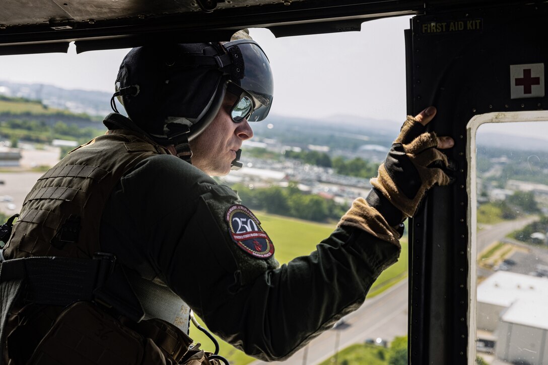 U.S. Marine Corps Gunnery Sgt. Taylor Gunderson, a helicopter crew chief with Marine Light Attack Helicopter Squadron-773, Marine Aircraft Group-49, 4th Marine Aircraft Wing, Marine Aircraft Group-49, 4th Marine Aircraft Wing, participates in an Orientation and Indoctrination Flight as part of Marine Week Nashville in Nashville, Tennessee, June 3, 2025. The O&I flights allowed an opportunity for community leaders around Nashville to see and experience Marine Corps aviation, and interact with the Marines maintaining and flying these aircraft. Throughout 2025, Marines across the globe will celebrate the 250th birthday of the Corps, commemorating service, sacrifice, and priding themselves on living 'Semper Fidelis' or 'Always Faithful' to their nation and to each other. (U.S. Marine Corps photo by Lance Cpl. Judith Ann Lazaro)