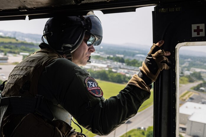 U.S. Marine Corps Gunnery Sgt. Taylor Gunderson, a helicopter crew chief with Marine Light Attack Helicopter Squadron-773, Marine Aircraft Group-49, 4th Marine Aircraft Wing, Marine Aircraft Group-49, 4th Marine Aircraft Wing, participates in an Orientation and Indoctrination Flight as part of Marine Week Nashville in Nashville, Tennessee, June 3, 2025. The O&I flights allowed an opportunity for community leaders around Nashville to see and experience Marine Corps aviation, and interact with the Marines maintaining and flying these aircraft. Throughout 2025, Marines across the globe will celebrate the 250th birthday of the Corps, commemorating service, sacrifice, and priding themselves on living 'Semper Fidelis' or 'Always Faithful' to their nation and to each other. (U.S. Marine Corps photo by Lance Cpl. Judith Ann Lazaro)