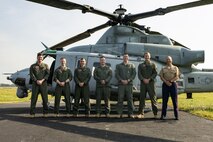 U.S. Marines with Marine Light Attack Helicopter Squadron-773 take a group photo during an Orientation and Indoctrination Flight as part of Marine Week Nashville at John C. Tune Airport, Nashville, Tennessee, June 3, 2025. The O&I flights allowed an opportunity for community leaders around Nashville to see and experience Marine Corps aviation and interact with the Marines maintaining and flying these aircraft. Throughout 2025, Marines across the globe will celebrate the 250th birthday of the Corps, commemorating service, sacrifice, and priding themselves on living 'Semper Fidelis' or 'Always Faithful' to their nation and to each other. (U.S. Marine Corps photo by Lance Cpl. Judith Ann Lazaro)