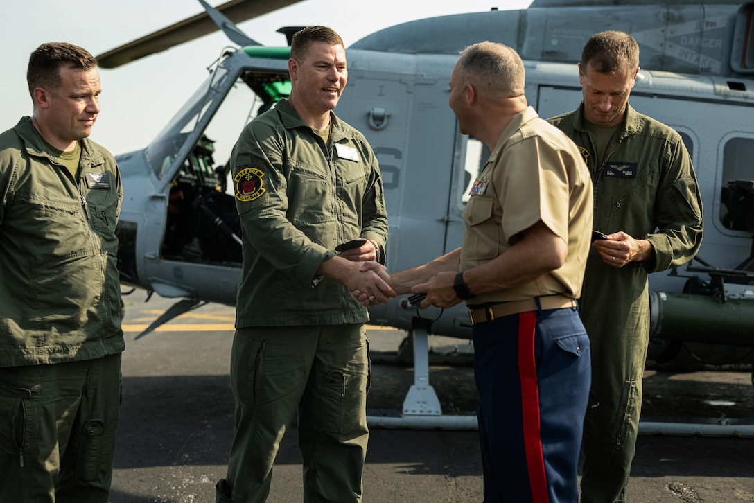 U.S. Marine Corps Col. J.J. Wilson, commanding officer of Special-Purpose Marine Air-Ground Task Force 250, hands a velcro patch to Marines with Marine Light Attack Helicopter Squadron-773 during an Orientation and Indoctrination Flight as part of Marine Week Nashville at John C. Tune Airport, Nashville, Tennessee, June 3, 2025. The O&I flights allowed an opportunity for community leaders around Nashville to see and experience Marine Corps aviation and interact with the Marines maintaining and flying these aircraft. Throughout 2025, Marines across the globe will celebrate the 250th birthday of the Corps, commemorating service, sacrifice, and priding themselves on living 'Semper Fidelis' or 'Always Faithful' to their nation and to each other. (U.S. Marine Corps photo by Lance Cpl. Judith Ann Lazaro)