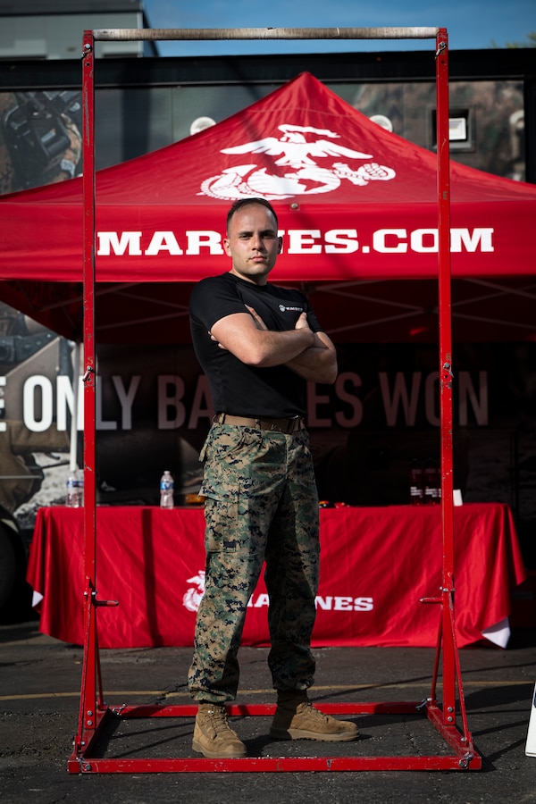 U.S. Marine Corps Sgt. Blake Inlow, a recruiter with Recruiting Sub-Station Brentwood, Recruiting Station Nashville, poses for a photo at a recruiting booth during Marine Week Nashville, in Nashville, Tennessee, June 5, 2025. Marines set up multiple equipment displays and recruiting booths during Marine Week to engage with the community of Nashville. Throughout 2025, Marines across the globe will celebrate the 250th birthday of the Corps, commemorating, service, sacrifice, and priding themselves on living ‘Semper Fidelis’ or ‘Always Faithful’ to their nation and to each other. (U.S. Marine Corps photo by Cpl. Vincent Needham)