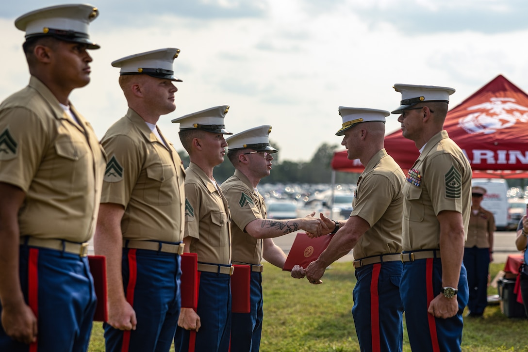 Sergeant Major of the Marine Corps Sgt. Maj. Carlos A. Ruiz and Lieutenant Colonel Dave Sierleja, the commanding officer of 2d Combat Engineer Battalion, shake hands with newly reenlisted Marines during the Cracker Barrel 400 brand activation as part of Marine Week Nashville 2025 at the Nashville Superspeedway, Nashville, Tennessee, June 1, 2025. Founded on November 10, 1775, the United States Marine Corps has served our nation honorably in every clime and place for 250 years. Throughout 2025, Marines across the globe will celebrate the 250th birthday of the Corps, commemorating service, sacrifice, and priding themselves on living 'Semper Fidelis' or 'Always Faithful' to their nation and to each other. (U.S. Marine Corps photo by Lance Cpl. Judith Ann Lazaro)