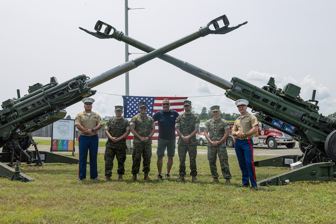 U.S. Marines from Marine Corps Installations East and an attendee from the Cracker Barrel 400 brand activation, takes a photo during Marine Week Nashville 2025 at the Nashville Superspeedway, Nashville, Tennessee, June 1, 2025. Founded on November 10, 1775, the United States Marine Corps has served our nation honorably in every clime and place for 250 years. Throughout 2025, Marines across the globe will celebrate the 250th birthday of the Corps, commemorating service, sacrifice, and priding themselves on living 'Semper Fidelis' or 'Always Faithful' to their nation and to each other. (U.S. Marine Corps photo by Lance Cpl. Judith Ann Lazaro)