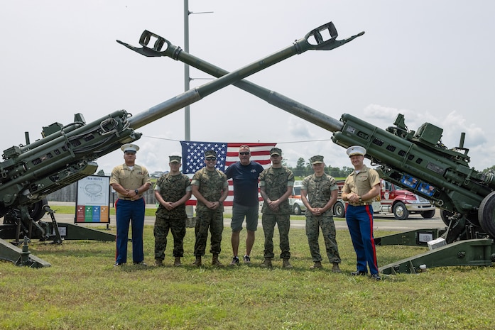 U.S. Marines from Marine Corps Installations East and an attendee from the Cracker Barrel 400 brand activation, takes a photo during Marine Week Nashville 2025 at the Nashville Superspeedway, Nashville, Tennessee, June 1, 2025. Founded on November 10, 1775, the United States Marine Corps has served our nation honorably in every clime and place for 250 years. Throughout 2025, Marines across the globe will celebrate the 250th birthday of the Corps, commemorating service, sacrifice, and priding themselves on living 'Semper Fidelis' or 'Always Faithful' to their nation and to each other. (U.S. Marine Corps photo by Lance Cpl. Judith Ann Lazaro)
