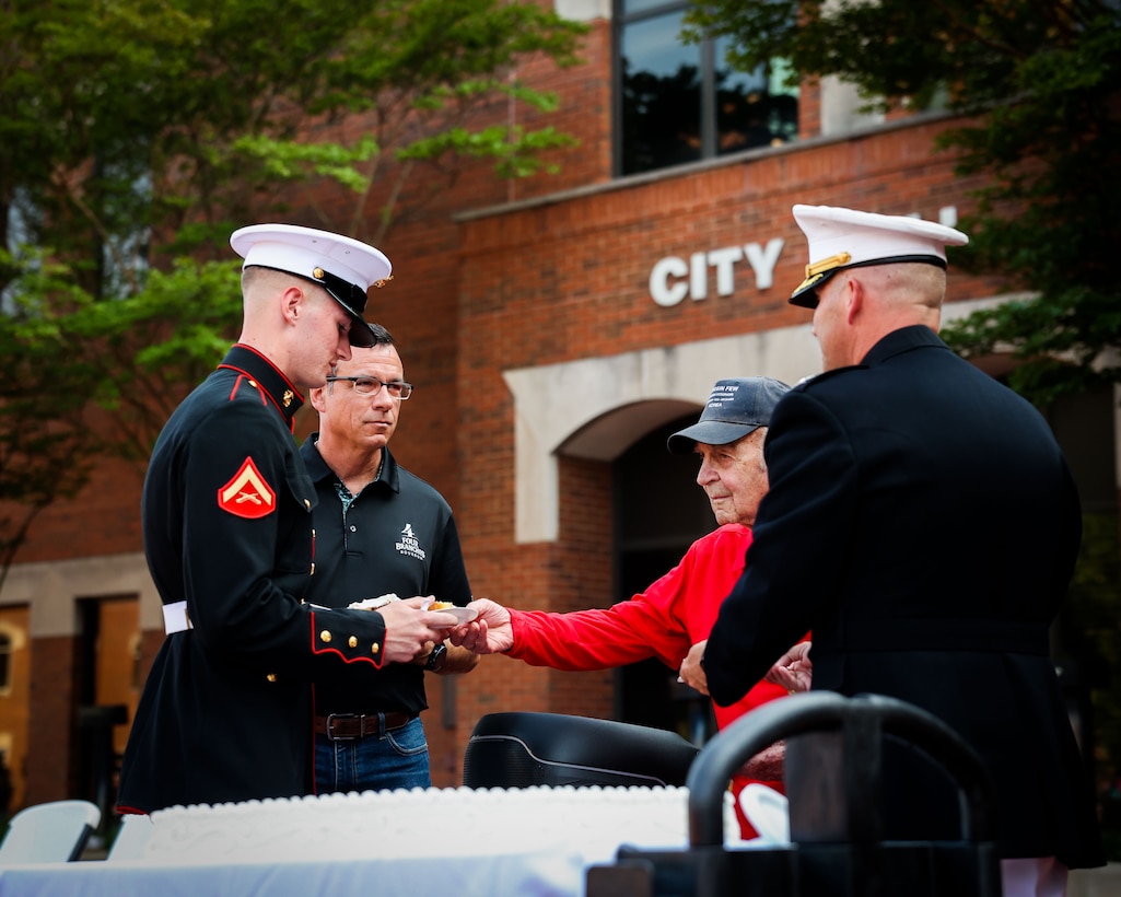 U.S. Marine Corps Lance Cpl. Culver Switzer, a rifleman with the United States Marine Corps Silent Drill Platoon, Marine Barracks Washington, is presented a piece of cake by retired Sgt. William Marvin Parks, a Marine Corps veteran of the Battle of the Chosin Reservoir, during a 250th Marine Corps birthday ceremony at City Hall in Murfreesboro, near Nashville, Tenn., June 4, 2025. As the youngest Marine present, Switzer participated in the traditional cake-cutting ceremony, receiving the first piece from the oldest Marine in attendance, symbolizing the passing of Marine Corps knowledge and tradition from one generation to the next. The Silent Drill Platoon’s presence in Nashville for Marine Week 2025 underscores the Corps’ commitment to honoring its legacy and connecting with communities across the country.

(U.S. Marine Corps photo by Lance Cpl. Brynn L. Bouchard)