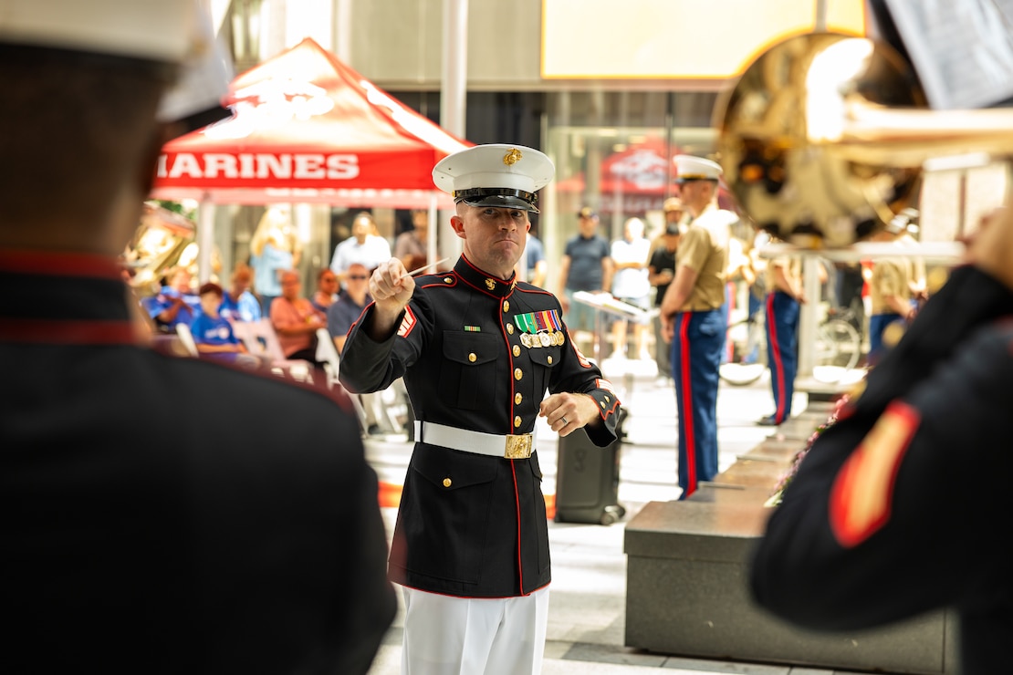 U.S Marine Corps Staff Sgt. Eric Potter, the enlisted conductor for the Quantico Marine Band assigned to Special Purpose Marine Air-Ground Task Force-250, leads the band in the opening ceremony during Marine Week Chicago, July 10, 2025. Throughout 2025, Marines across the globe will celebrate the 250th birthday of the Corps, commemorating service, sacrifice, and priding themselves on living ‘Semper Fidelis’ or ‘Always Faithful’ to their nation and to each other. (U.S. Marine Corps photo by Lance Cpl. Elijua Guel)