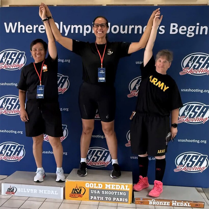 Team Army on the podium at the Olympic Training Center. Chief Warrant Officer 4 Tsuhako (left), Lt. Col. Sanders (middle) and Master Sgt. Pyle-Vandersys (right).