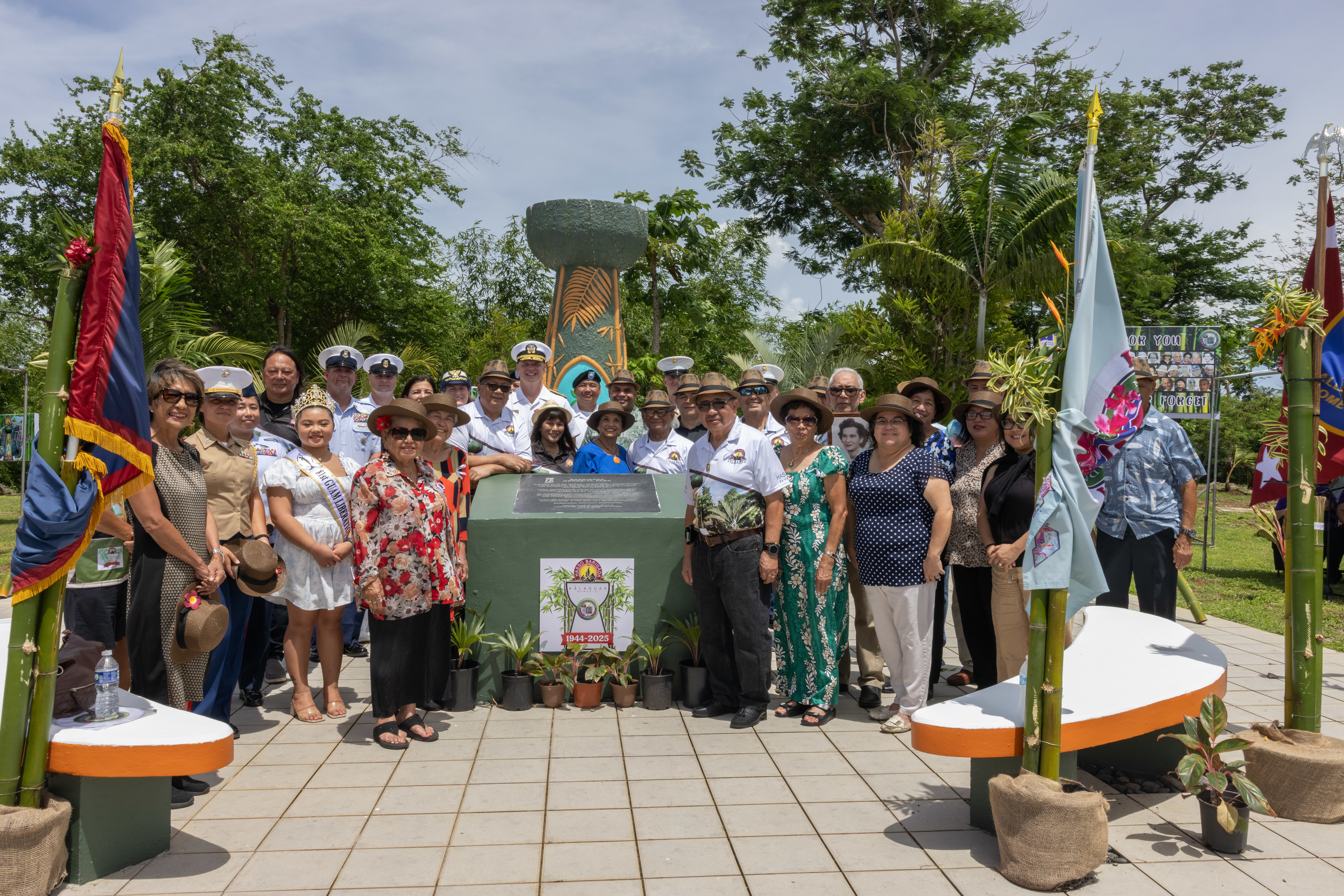 U.S. servicemembers, World War II survivors, and Guam politicians pose for a photo at the Kålaguak Memorial in Barigåda, Guam, July 11, 2025. Tiyan, Barigåda was the site where the CHamoru population during World War II was forced by the Imperial Japanese Forces to build an airstrip. The Kålaguak memorial service is one of many held across the island to commemorate the 81st anniversary of the liberation of Guam. (U.S. Marine Corps photo by Lance Cpl. Rey Moreno Marilao)