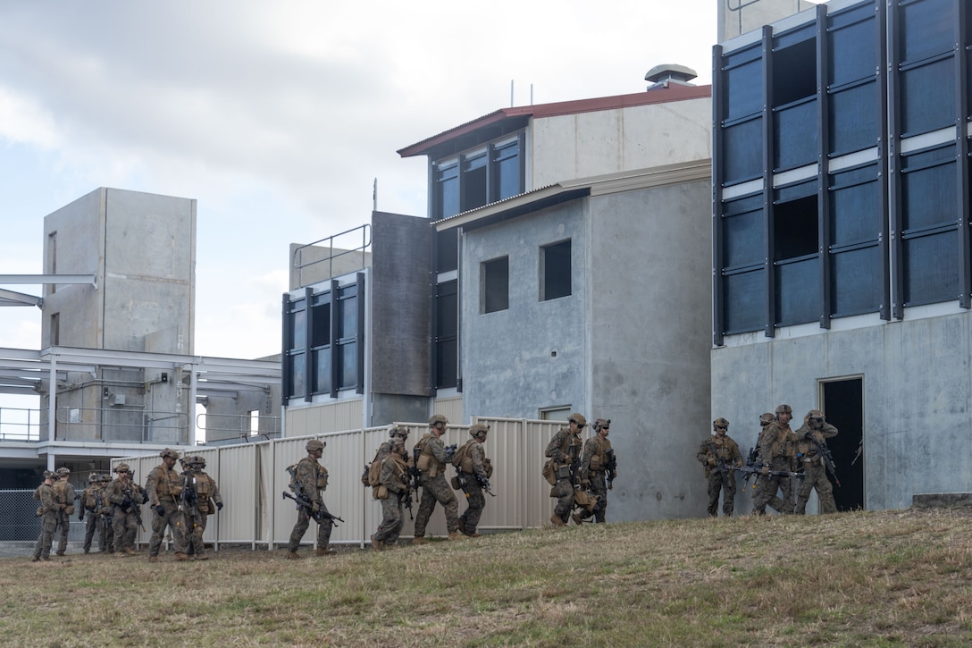 U.S. Marines with Baker Company, Battalion Landing Team 1st Battalion, 7th Marine Regiment, 31st Marine Expeditionary Unit, clear a building during a simulated air assault at Shoal Water Bay Training Area, Queensland, Australia, July 5th, 2025. Marines participated in a simulated air assault exercise in order to increase their lethality in a realistic combat scenario. The 31st MEU is operating aboard ships of the USS America Amphibious Ready Group in the 7th Fleet area of operations, the U.S. Navy’s largest forward-deployed numbered fleet, and routinely interacts and operates with allies and partners in preserving a free and open Indo-Pacific region. (U.S. Marine Corps photo by Lance Cpl. Trevor BishopWilliams)