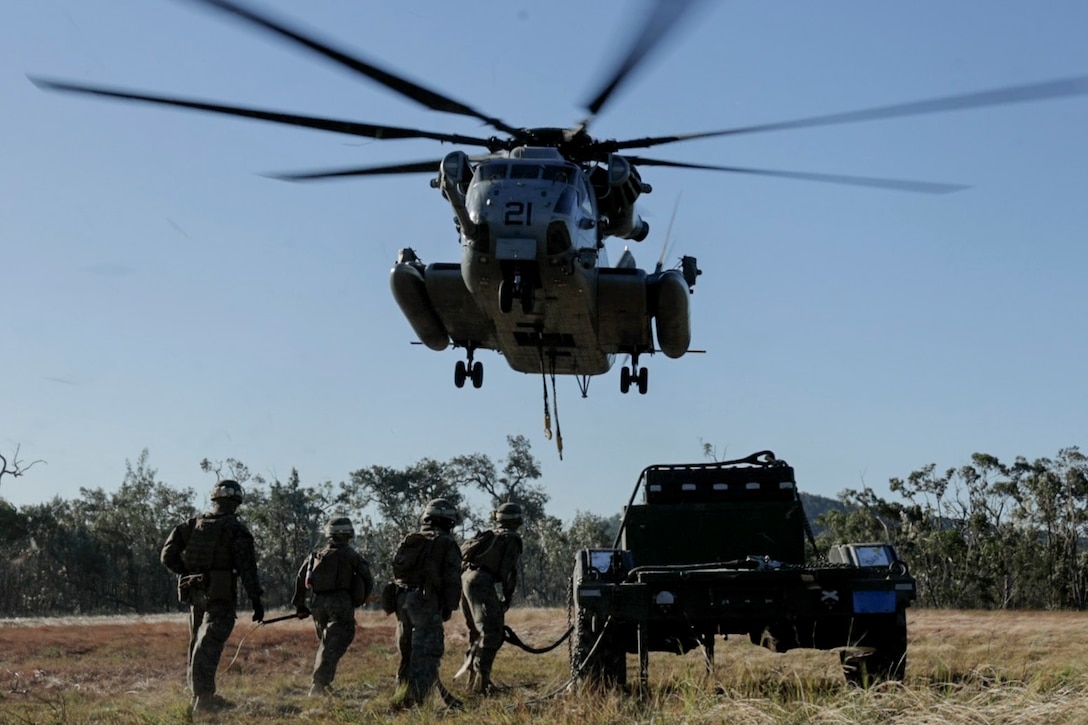 U.S. Marines with Combat Logistics Company-Alpha, Combat Logistics Battalion 31, 31st Marine Expeditionary Unit, prepare to attach a trailer to a U.S. Marine Corps CH-53E Super Stallion helicopter assigned to Marine Medium Tiltrotor Squadron 262 (Rein.), during a helicopter support transportation exercise at Sam Hill Airfield, Queensland, Australia, July 1, 2025. The Marines with CLB-31 conducted HST operations to maintain and improve their aerial transportation skills in rural training situations. The 31st MEU is operating aboard ships of the USS America Amphibious Ready Group in the 7th Fleet area of operations, the U.S. Navy’s largest forward-deployed numbered fleet, and routinely interacts and operates with allies and partners in preserving a free and open Indo-Pacific region. (U.S. Marine Corps photo by Lance Cpl. Skilah Sanchez)