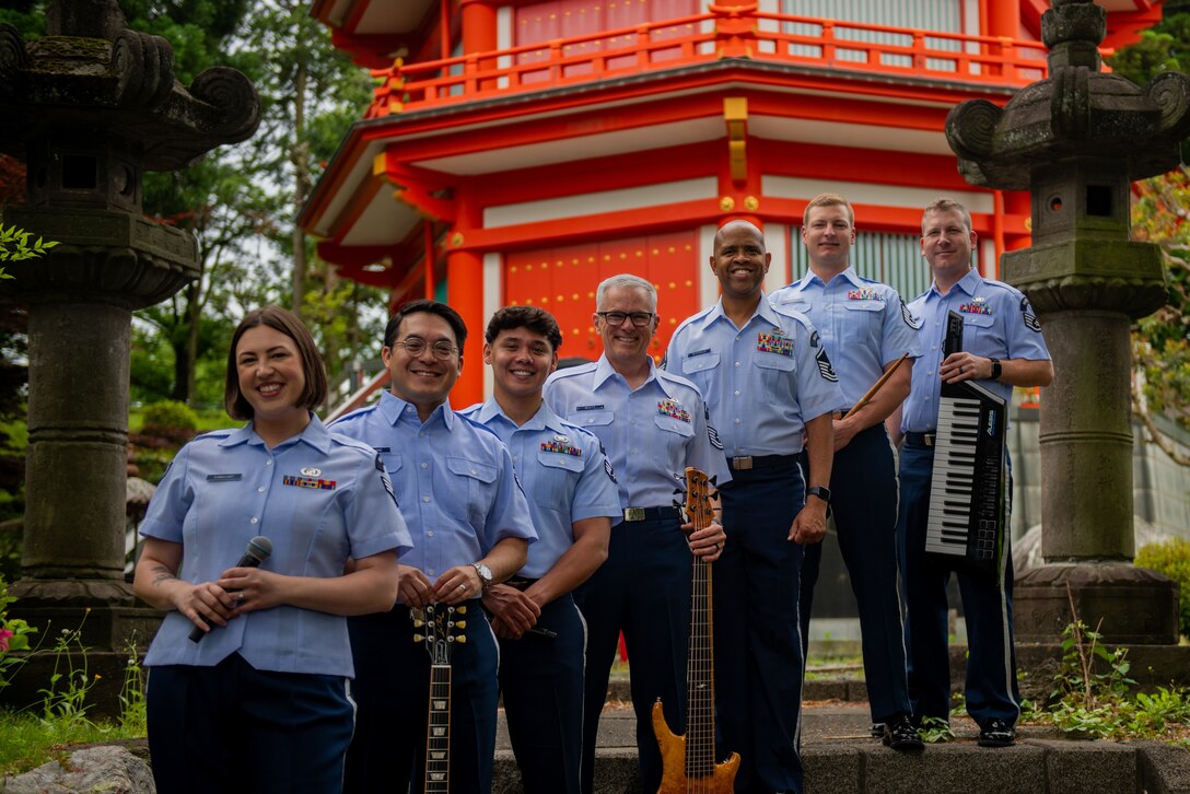 Musical Performance team posing for a picture in front of a pagoda.