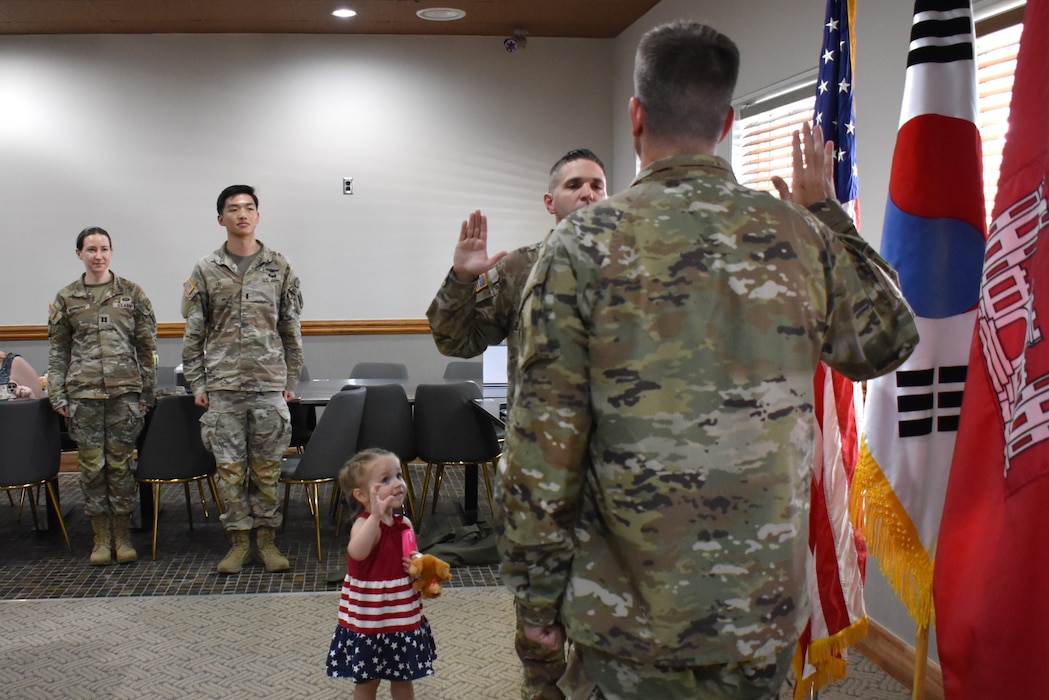 Staff Sgt. Cullen Ellis, quality assurance representative, U.S. Army Corps of Engineers – Far East District, reaffirmed his commitment to service by signing an indefinite reenlistment contract on July 9, 2025, at Camp Henry, South Korea. Col. Jeremiah Willis, commander, USACE FED, administered the Oath of Enlistment at the ceremony. Ellis’ daughter, Marie, almost 3, joined him for the occasion.