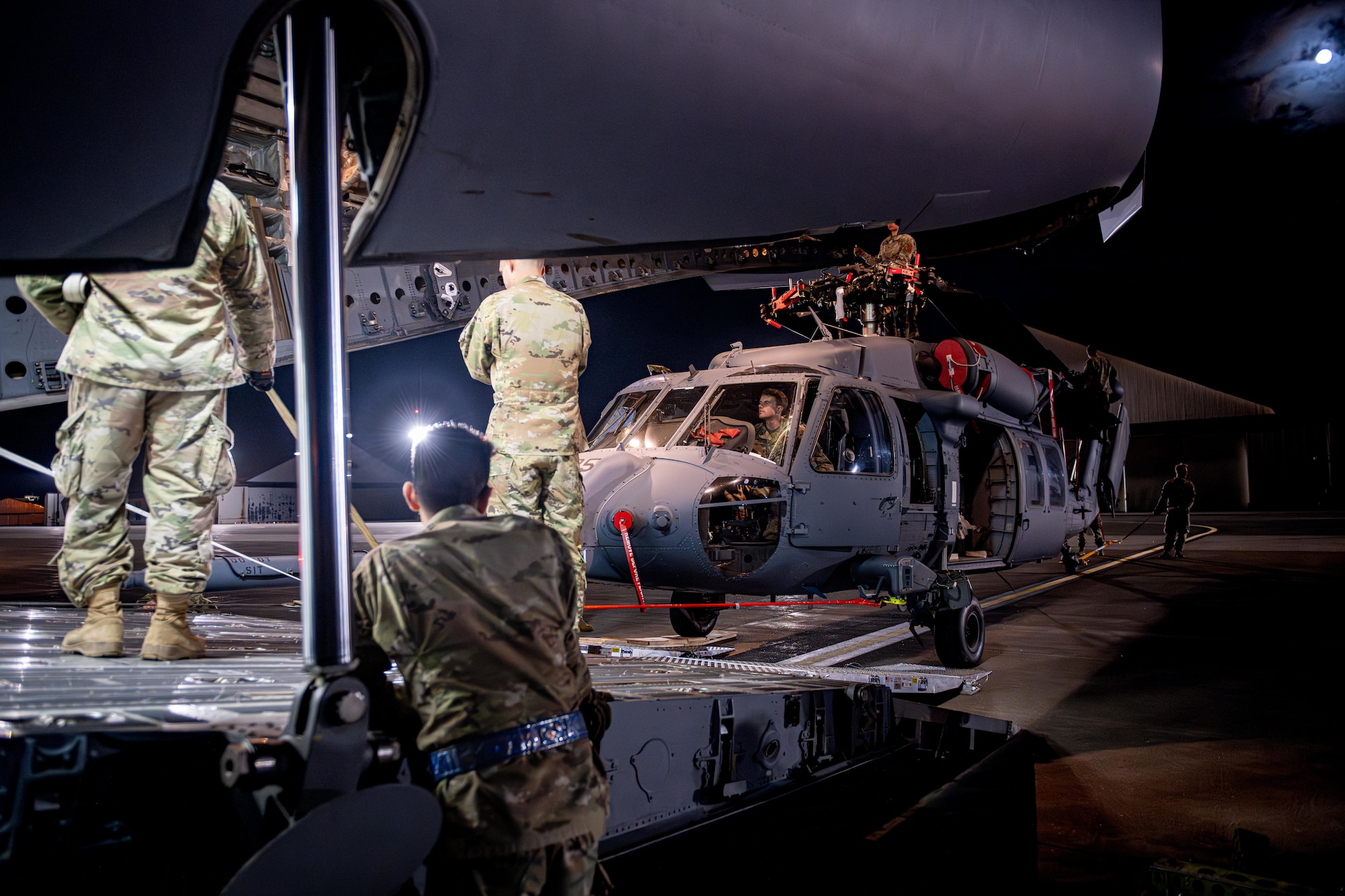 U.S. Air National Guard Airmen assigned to the 106th Logistics Readiness Squadron and the 129th Rescue Wing offload a U.S. Air Force HH-60 Pave Hawk from a C-17 Globemaster III in support of exercise Resolute Force Pacific (REFORPAC) 2025.