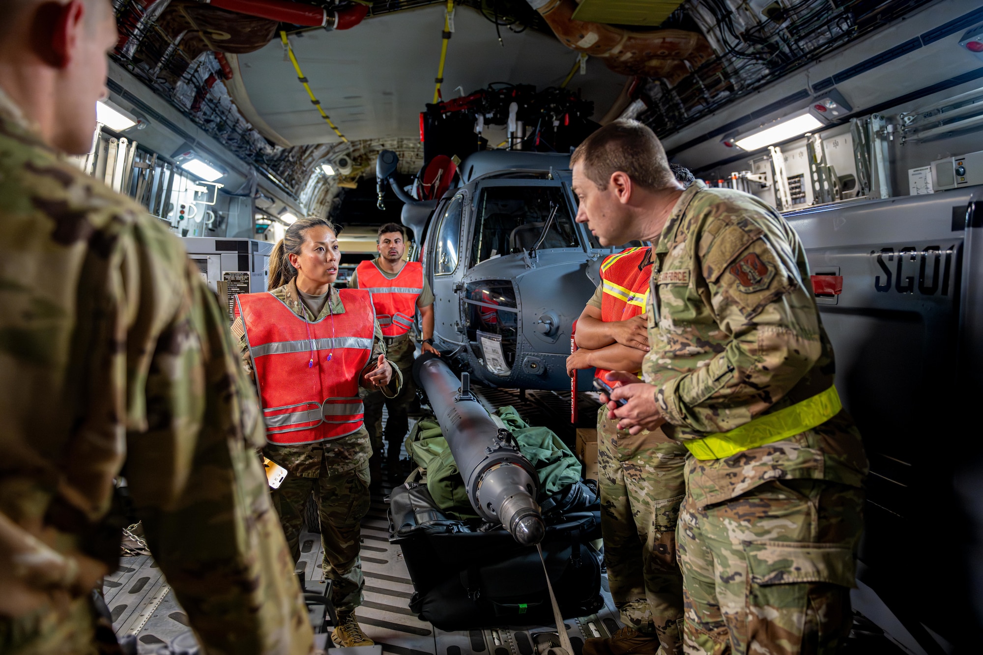 U.S. Air National Guard Airmen assigned to the 106th Logistic Readiness Squadron and the 129th Rescue Wing discuss plans to offload cargo from a C-17 Globemaster III in support of exercise Resolute Force Pacific (REFORPAC) 2025.