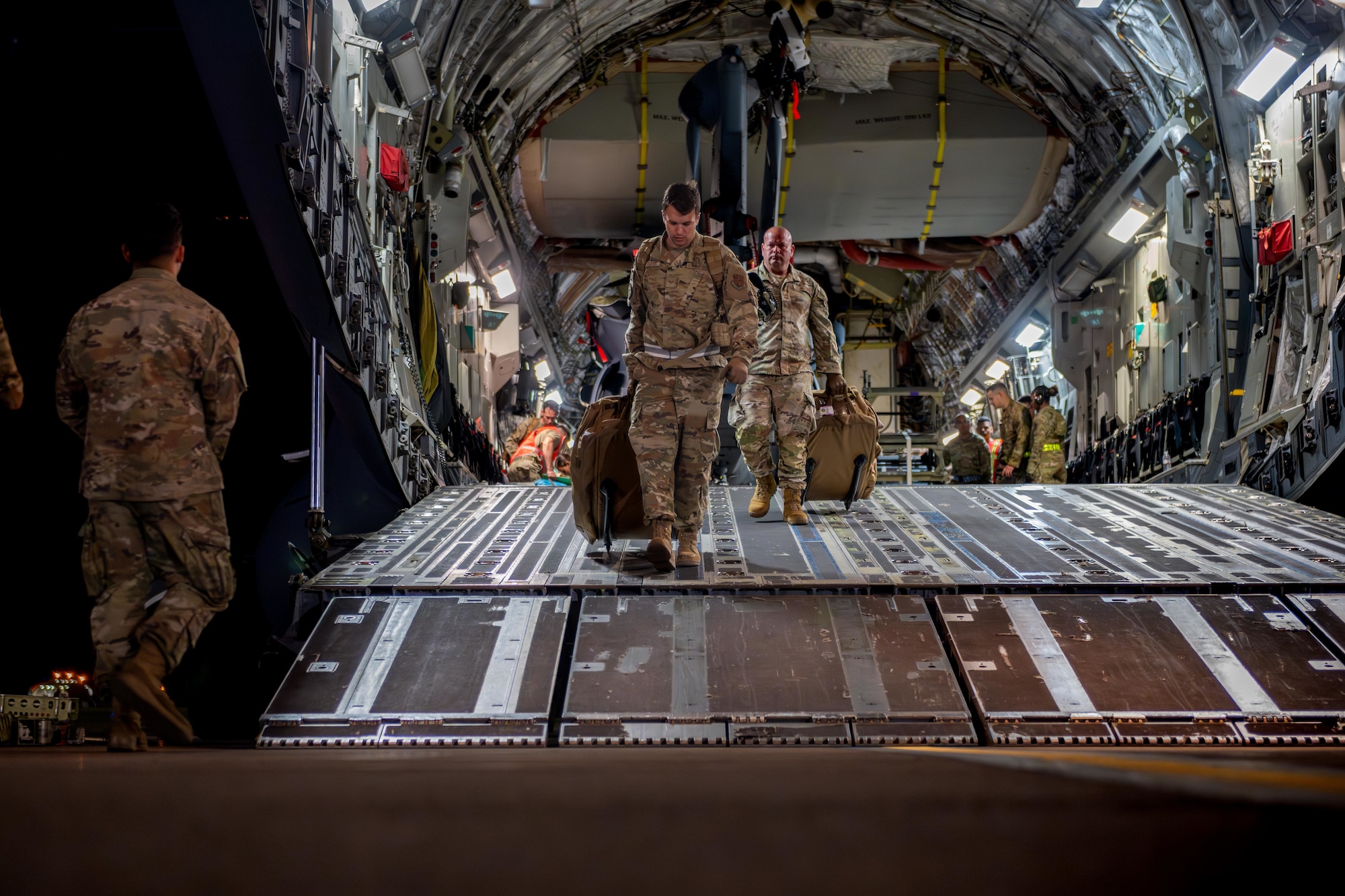 U.S. Air National Guard Airmen assigned to the 106th Logistics Readiness Squadron and the 129th Rescue Wing exit a C-17 Globemaster III in support of exercise Resolute Force Pacific 2025.