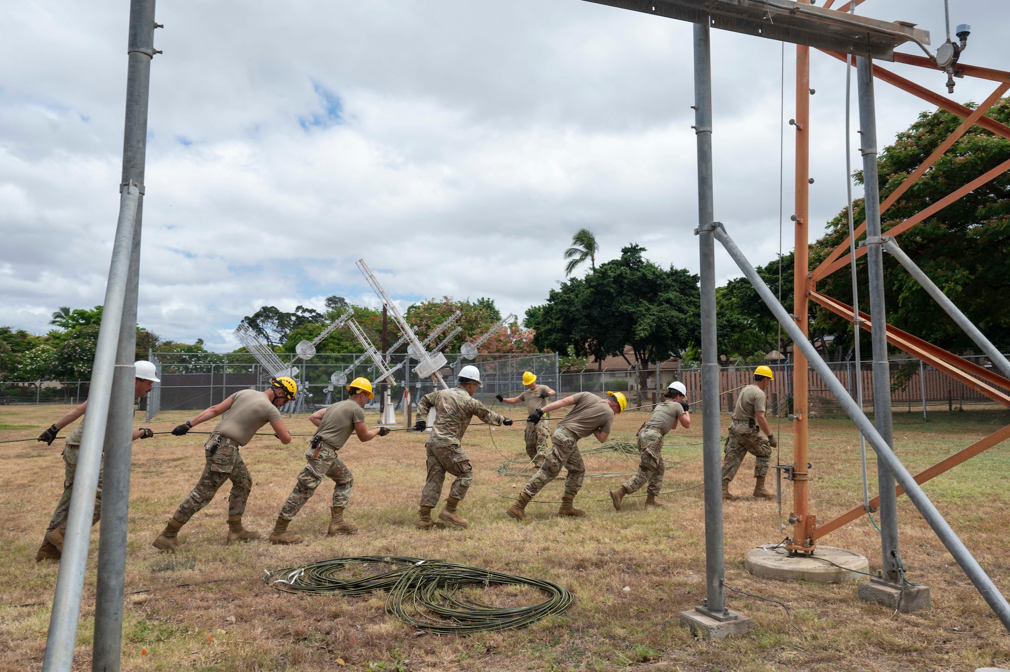 A team comprised of U.S. Air National Guard Airmen from the 202nd, 205th, and 210th Engineering Installation Squadrons, band together to install a fiber optic cable on Joint Base Pearl Harbor-Hickam, Hawaii. The Fiber Deep project underway at Joint Base Pearl Harbor-Hickam, a transformation spearheaded by an U.S. Air National Guard engineering installation team, is set to save approximately $10 million dollars, while simultaneously fortifying against cyber threats. (U.S. Air Force photo by Senior Airman Melody Bordeaux)