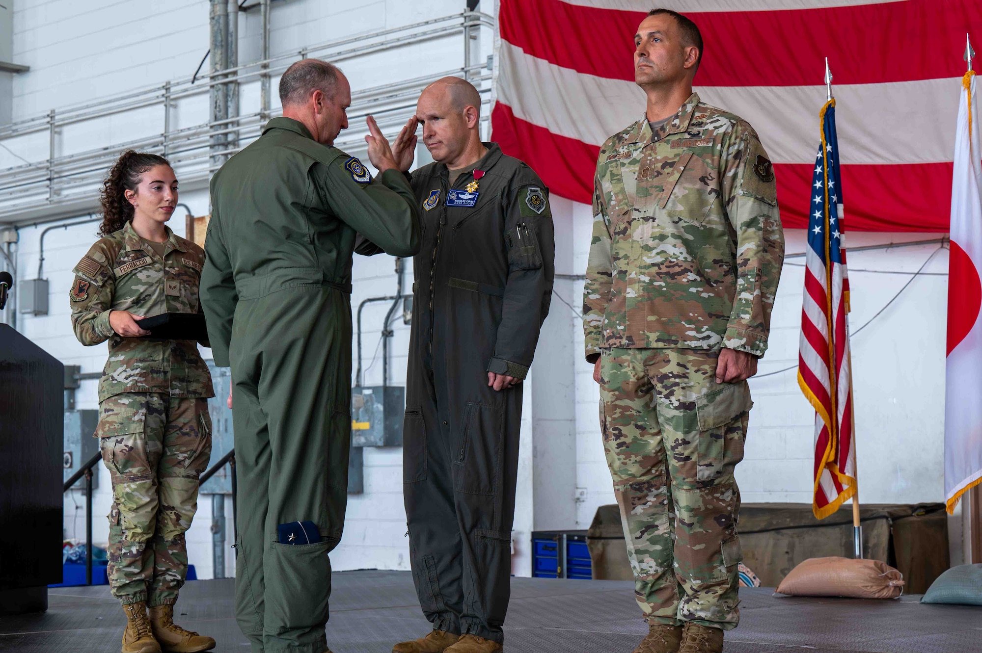 Service members salute each other.