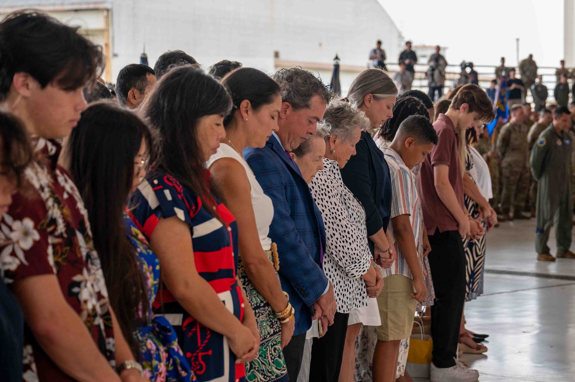 Guests heads bowed in prayer.