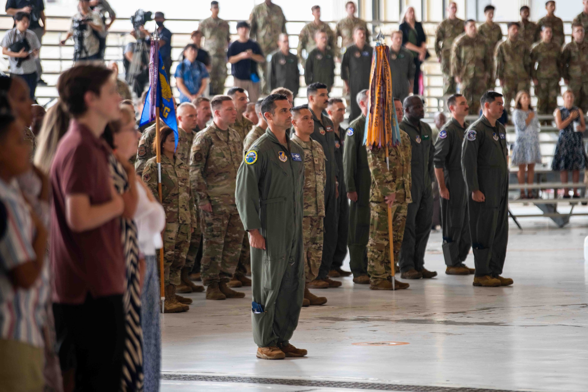 Service members stand at attention.