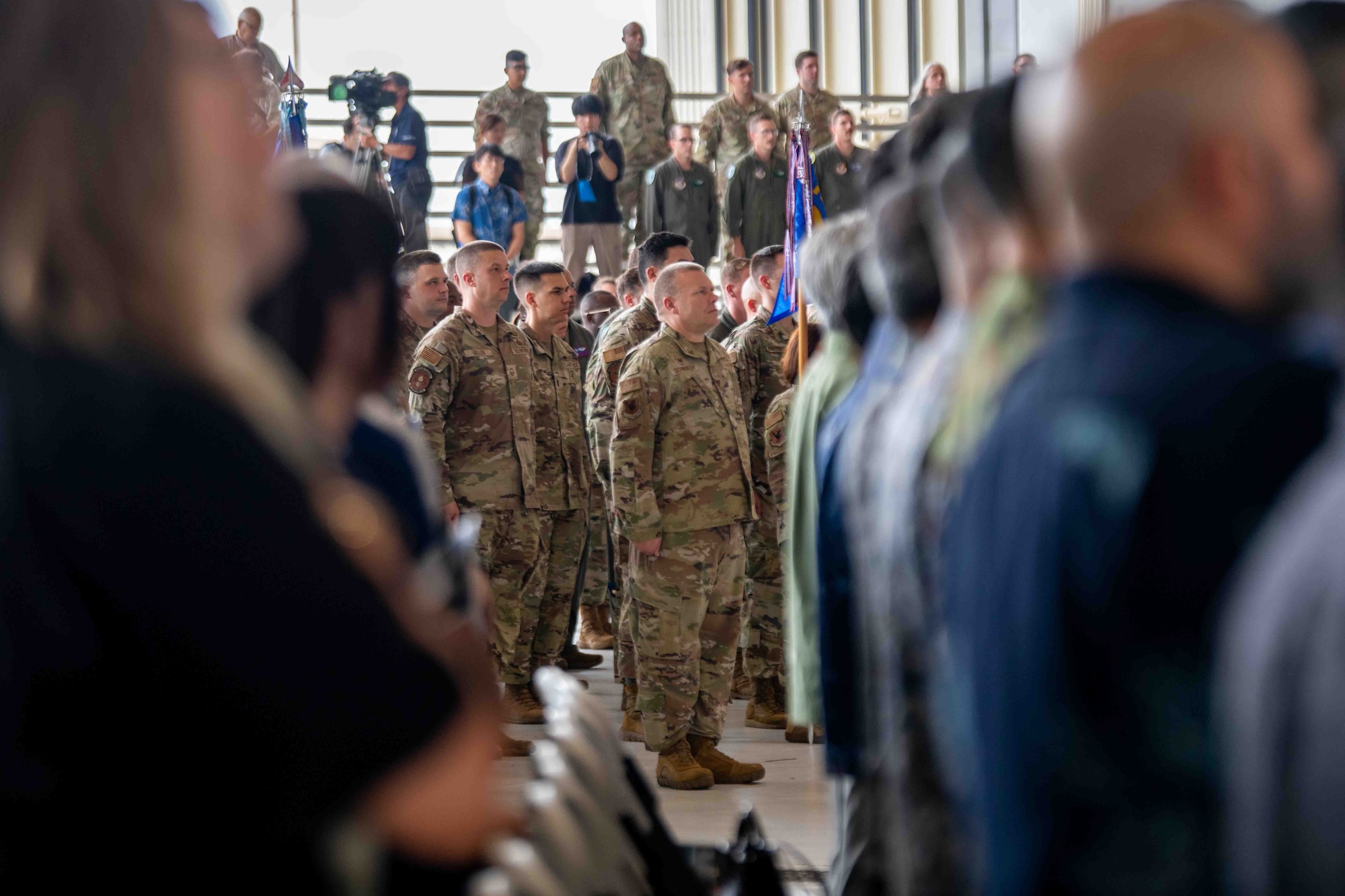 Service member stands at attention.