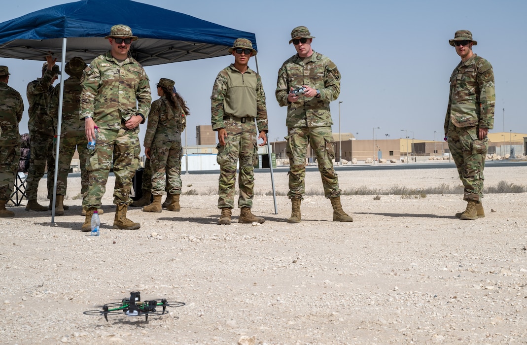A group of U.S. Airmen practice flying a quadcopter drone within the U.S. Central Command area of responsibility, May 26, 2025. TF-99 is an innovation cell that tests and refines new technologies, ensuring that they can respond to pacing threats with advanced operational solutions. (U.S. Air Force photo by Senior Airman Amanda Jett)