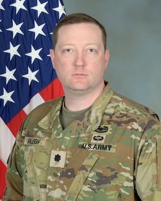 Official photo of Lieutenant Colonel Sean C. Raleigh with U.S. flag in background