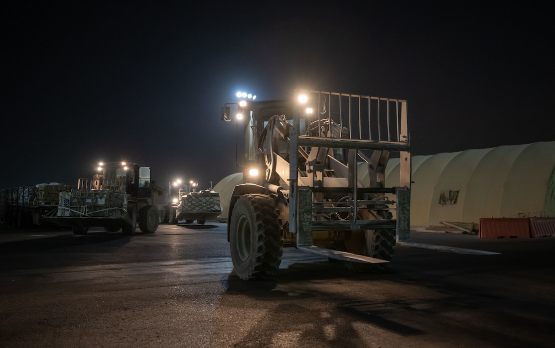 U.S. Airmen preposition forklifts for a cargo upload within the U.S. Central Command area of responsibility, June 14, 2025. The rapid movement of military cargo is essential throughout the AOR for sustaining operations in contested, austere environments. (U.S. Air Force photo by Senior Airman Amanda Jett)