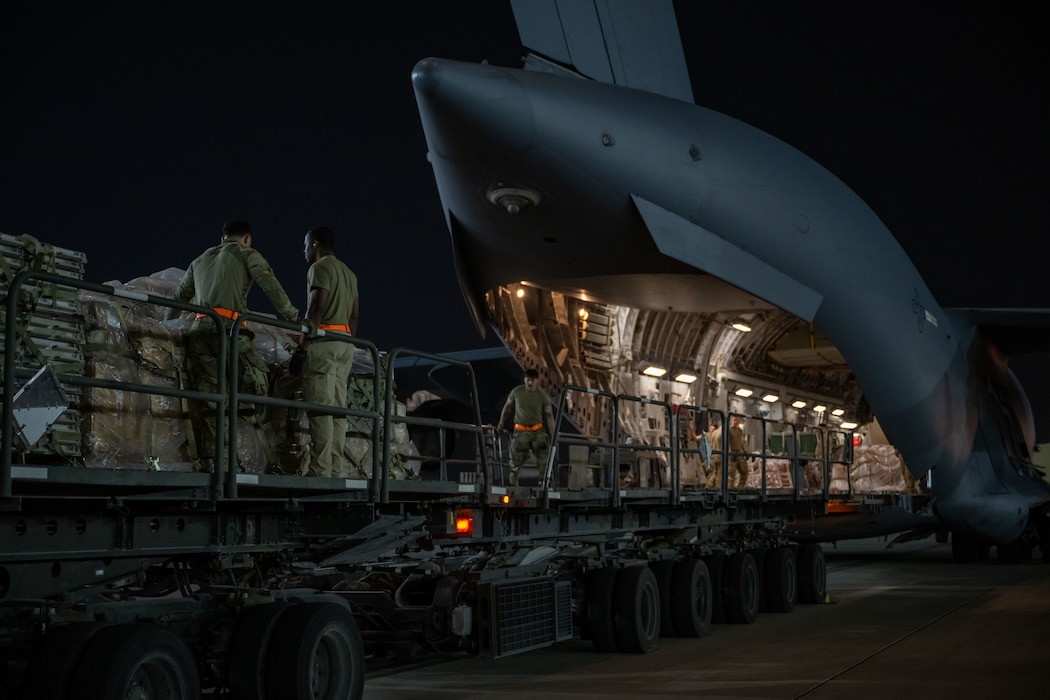 U.S. Airmen assigned to the 379th Expeditionary Air Base Group, upload cargo onto a C-17 Globemaster III within the U.S. Central Command area of responsibility, June 15, 2025. The 379th EABG serves as a key component of the 379th Air Expeditionary Wing, supporting missions ranging from humanitarian airlift and mission-essential combat power to aeromedical evacuation and intelligence operations across multiple theaters. (U.S. Air Force photo by Senior Airman Amanda Jett)