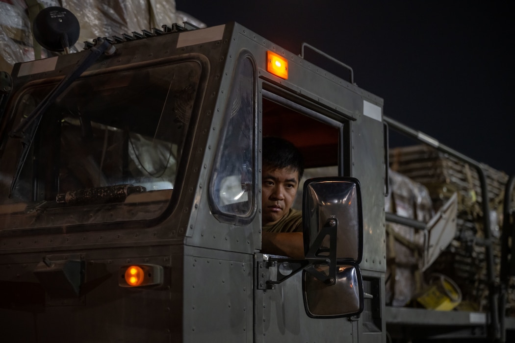 A U.S. Airman assigned to the 379th Expeditionary Air Base Group operates a K-loader during cargo upload within the U.S. Central Command area of responsibility, June 14, 2025. The rapid movement of military cargo is essential throughout the AOR for sustaining operations in contested austere environments. (U.S. Air Force photo by Senior Airman Amanda Jett)