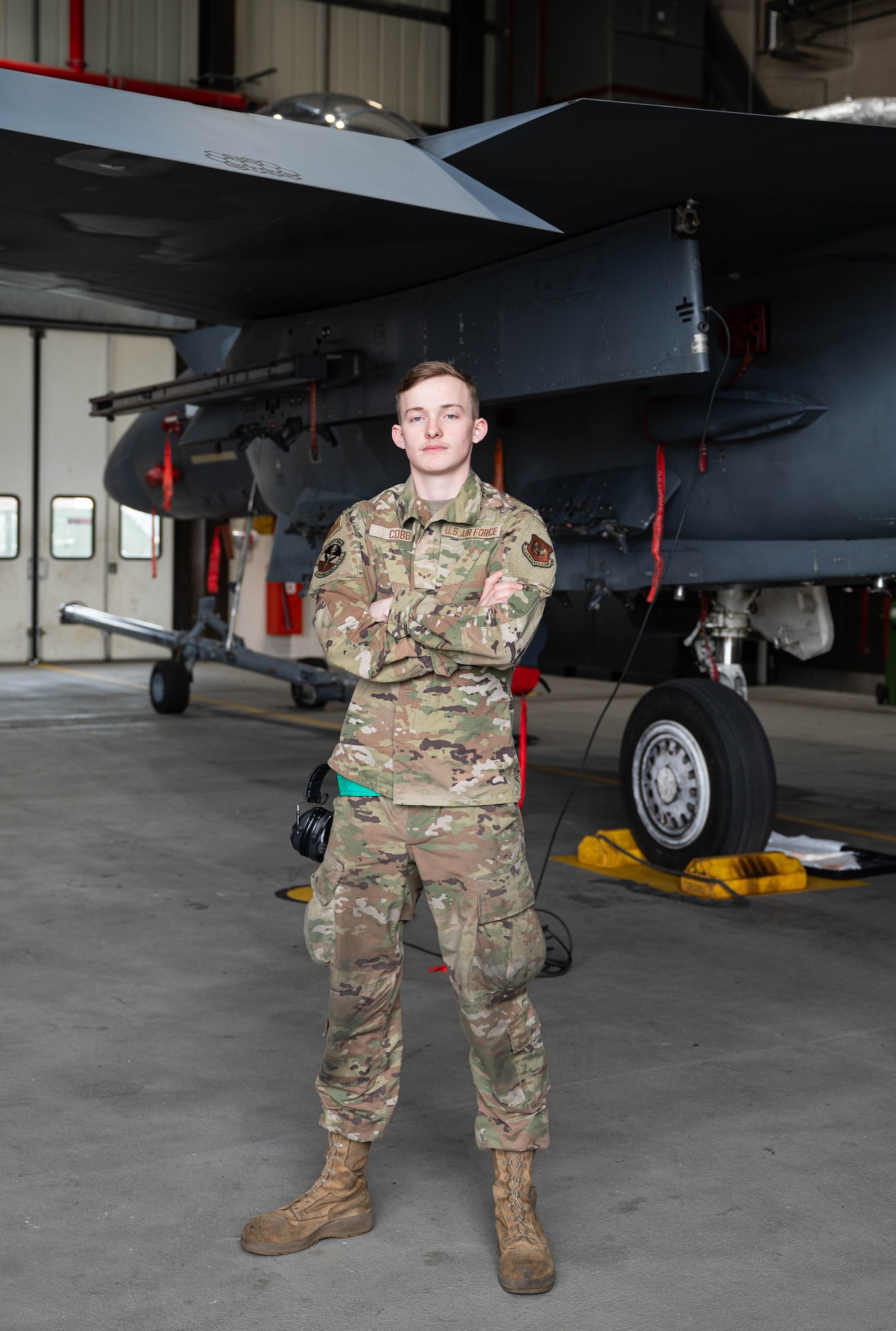 U.S. Air Force Airman 1st Class Jackson Cobb, 48th Component Maintenance Squadron aircraft fuel systems apprentice, poses in front of a F-15E Strike Eagle