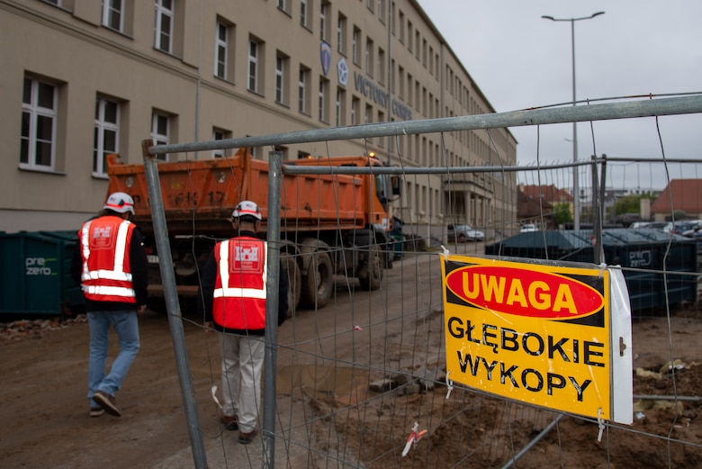 two people walking through construction zone