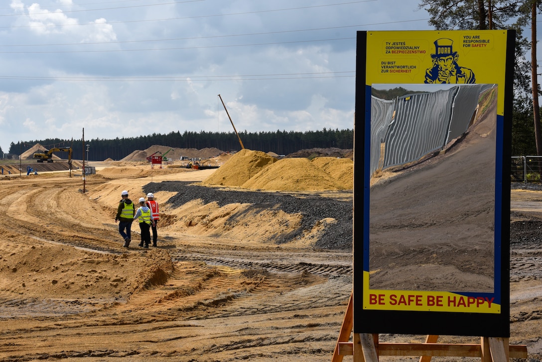three people walking towards construction site