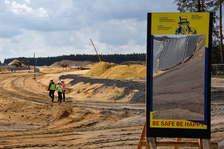 three people walking towards construction site