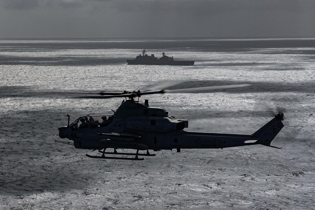 U.S. Marine Corps AH-1Z Viper helicopter with Marine Medium Tiltrotor Squadron 263 (Reinforced), 22nd Marine Expeditionary Unit (Special Operations Capable), flies over the Atlantic Ocean from the U.S. Navy Wasp-class amphibious assault ship USS Iwo Jima (LHD 7), during a live-fire exercise in support of Composite Training Unit Exercise while underway in the Atlantic Ocean, July 5, 2025. During COMPTUEX, the IWO ARG and 22nd MEU(SOC), refine tactics, techniques, and procedures to execute warfighting functions that enhance operational readiness and lethality as a unified IWOARG/22 MEU(SOC) team. (U.S. Marine Corps photo by Cpl. Emily Hazelbaker)