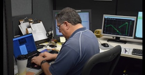 Warren Madden works on his computer.