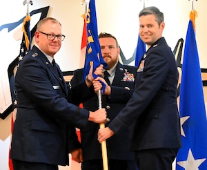 Lt. Col. Brian Scott receives the unit guidon from Lt. Gen. Luke Ahmann, commander of the Continental U.S. North American Aerospace Defense Region – First Air Force (Air Forces Northern and Air Forces Space).