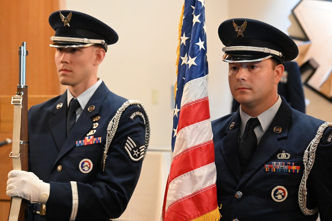 Members of the honor guard present arms at the change of command ceremony.