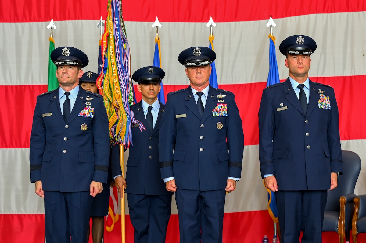 Maj. Gen. Paul Moga, Brig. Gen. Tad Clark and Col. Beau Diers standing at attention.