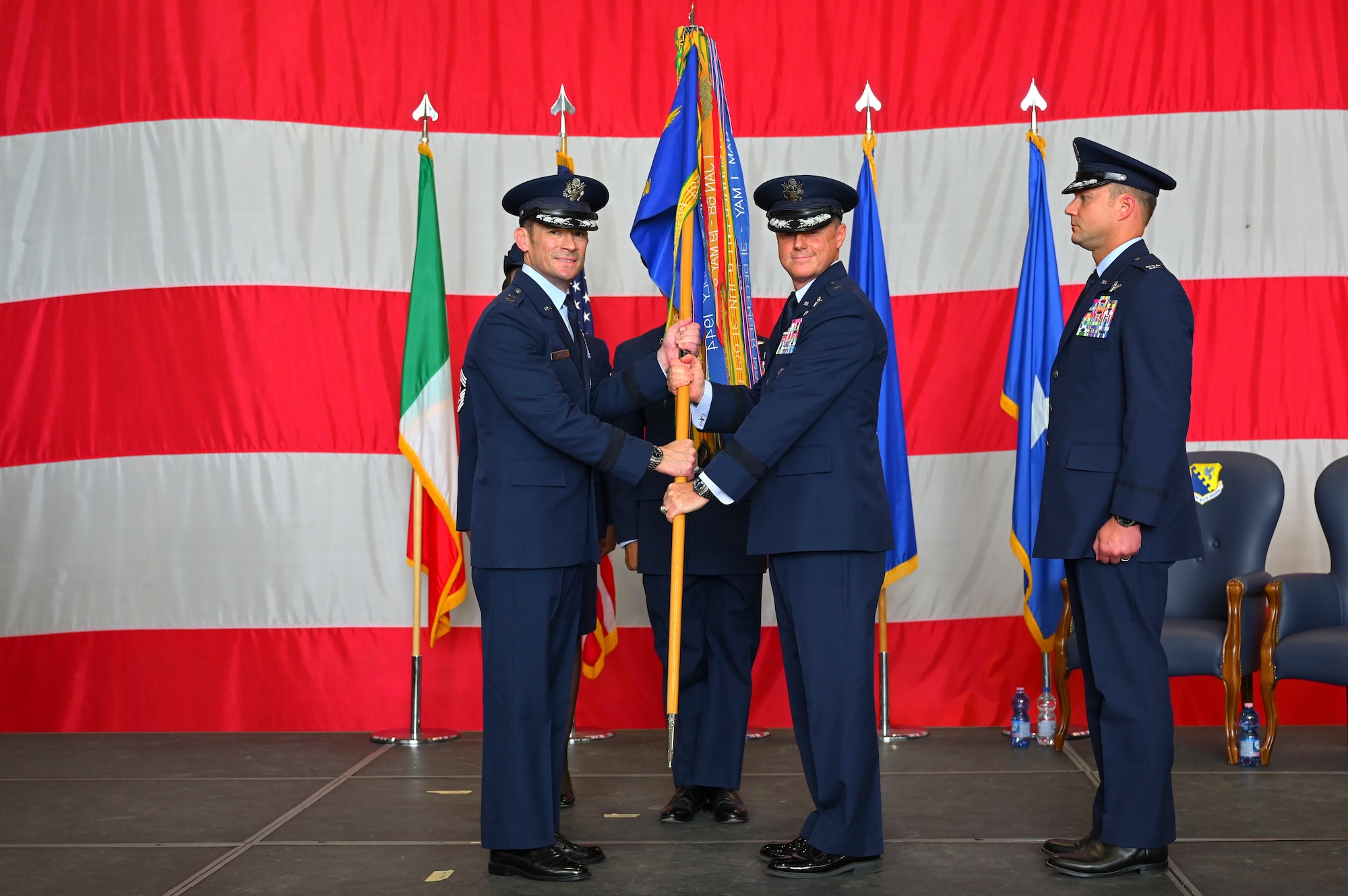 Brig. Gen. Tad Clark passing the guidon to to Maj. Gen. Paul Moga.
