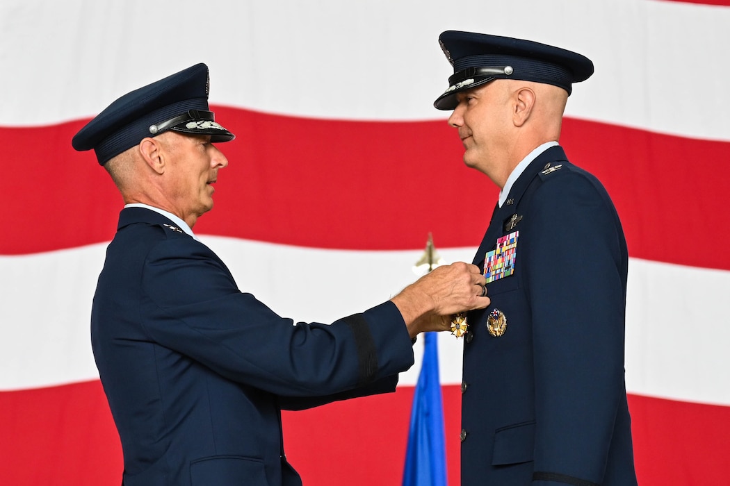 U.S. Air Force Maj. Gen. Gregory Kreuder, 19th Air Force commander, pins the Legion of Merit medal on Col. Jeff Marshall, outgoing 97th Air Mobility Wing (AMW) commander, during the wing change of command ceremony at Altus Air Force Base, Oklahoma, July 11, 2025. Marshall took command of the 97th AMW on July 14, 2023. (U.S. Air Force photo by Airman 1st Class Lauren Torres)