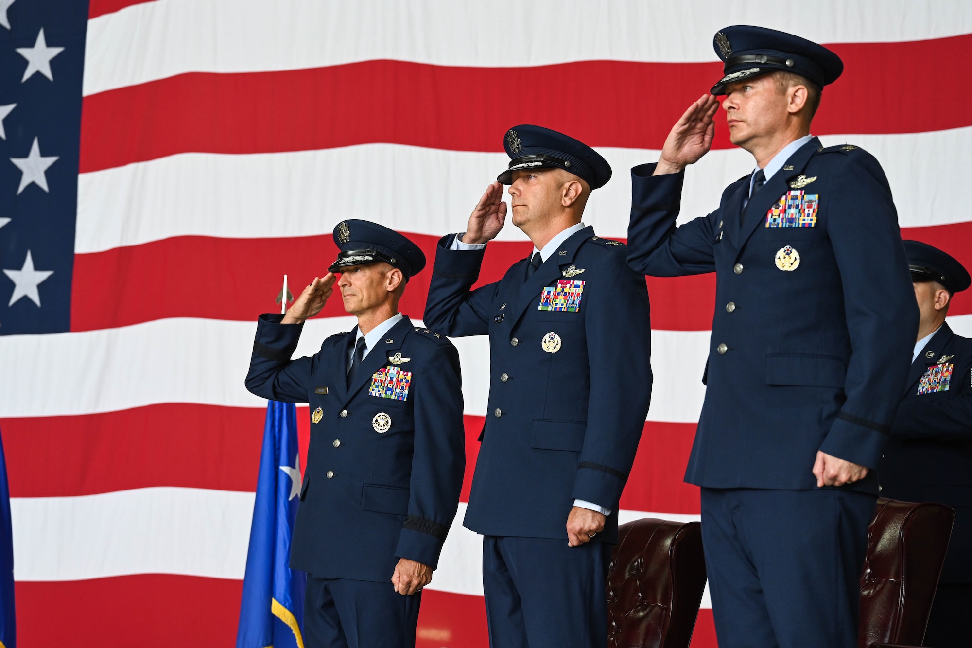 From left, U.S. Air Force Maj. Gen. Gregory Kreuder, 19th Air Force commander, Col. Jeff Marshall, outgoing 97th Air Mobility Wing (AMW) commander, Col. Richard Kind, incoming 97th AMW commander, salutes during the wing change of command ceremony at Altus Air Force Base, Oklahoma, July 11, 2025. Kreuder served as the presiding official for the ceremony. (U.S. Air Force photo by Airman 1st Class Lauren Torres)