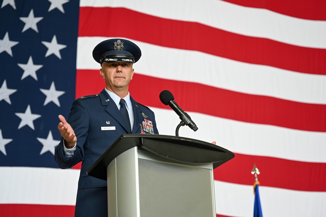 U.S. Air Force Col. Jeff Marshall, outgoing 97th Air Mobility (AMW) commander, gives farewell remarks during the wing change of command ceremony at Altus Air Force Base, Oklahoma, July 11, 2025. Marshall relinquished command of the 97th AMW to Colonel Richard Kind during the ceremony. (U.S. Air Force photo by Airman 1st Class Lauren Torres)