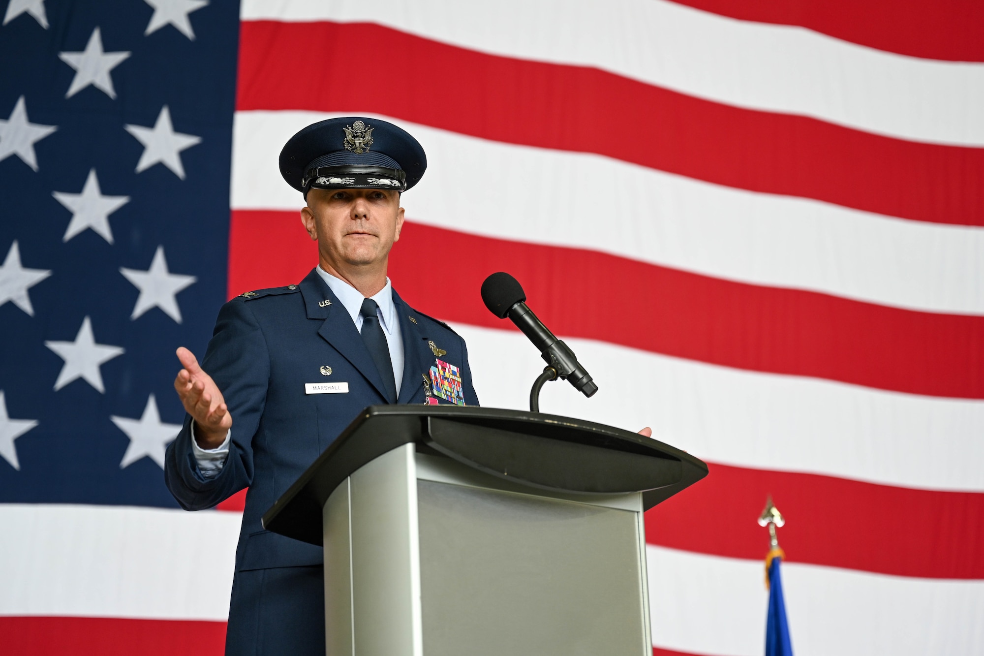 U.S. Air Force Col. Jeff Marshall, outgoing 97th Air Mobility (AMW) commander, gives farewell remarks during the wing change of command ceremony at Altus Air Force Base, Oklahoma, July 11, 2025. Marshall relinquished command of the 97th AMW to Colonel Richard Kind during the ceremony. (U.S. Air Force photo by Airman 1st Class Lauren Torres)